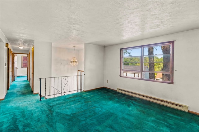 carpeted spare room with a baseboard heating unit, a notable chandelier, and a textured ceiling