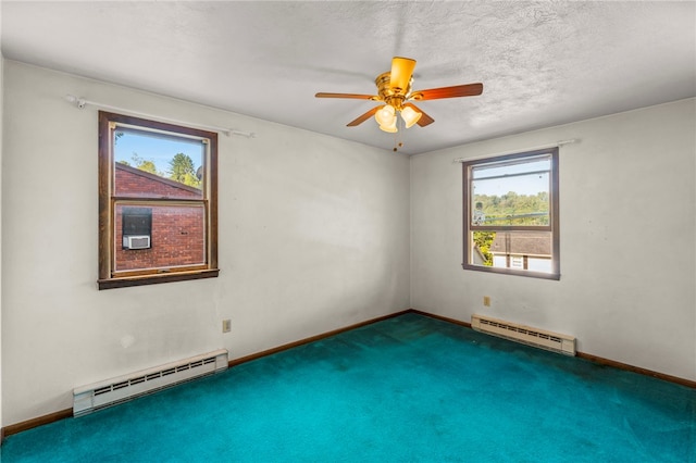 spare room with ceiling fan, baseboard heating, carpet, and a textured ceiling