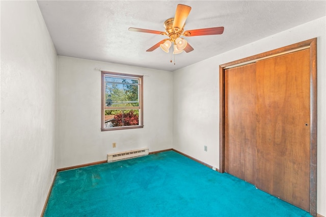 carpeted spare room featuring ceiling fan, baseboard heating, and a textured ceiling