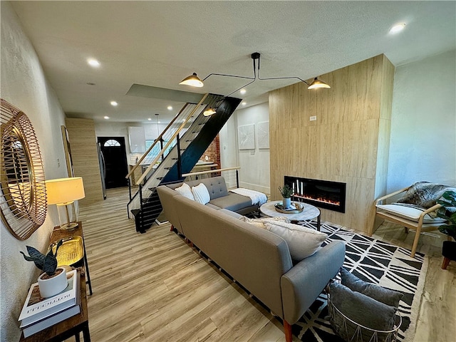 living room with light wood-type flooring and a fireplace