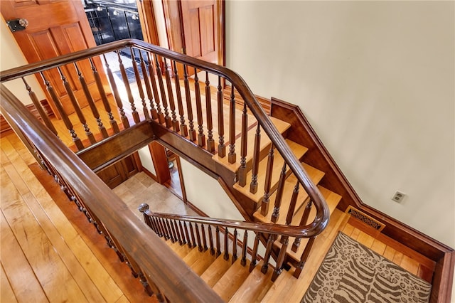 staircase featuring wood-type flooring