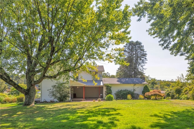 view of front of house with a front lawn and a patio