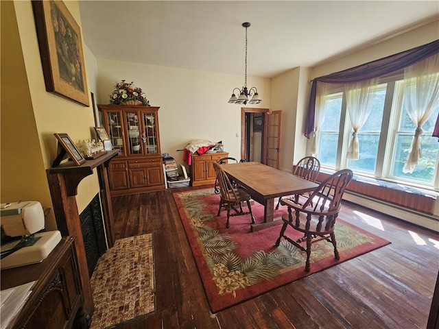 dining area featuring a baseboard radiator, dark wood-type flooring, and an inviting chandelier