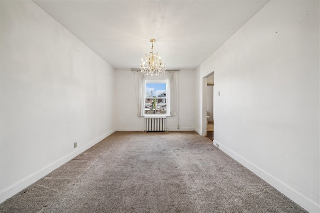 unfurnished room with radiator, an inviting chandelier, and carpet floors