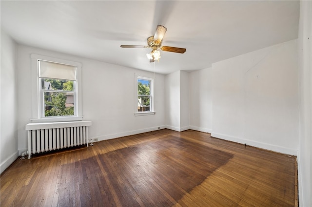 unfurnished room featuring ceiling fan, dark hardwood / wood-style floors, and radiator