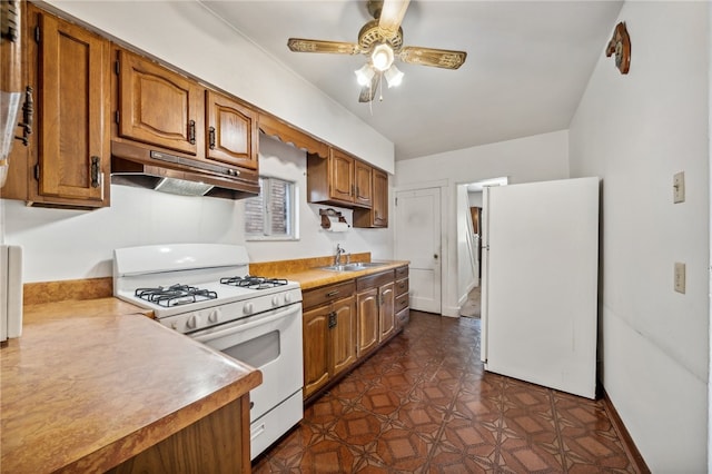 kitchen with ceiling fan, sink, and white appliances