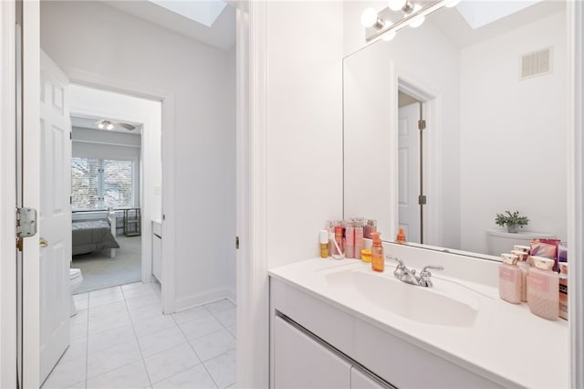 bathroom featuring toilet and vanity