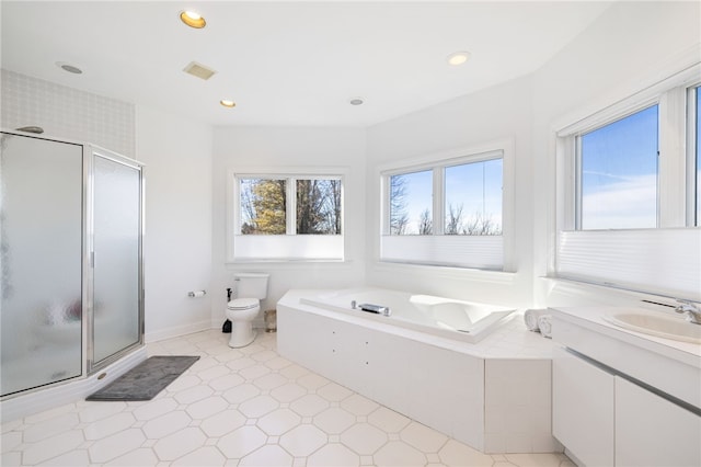 full bathroom featuring vanity, toilet, and independent shower and bath