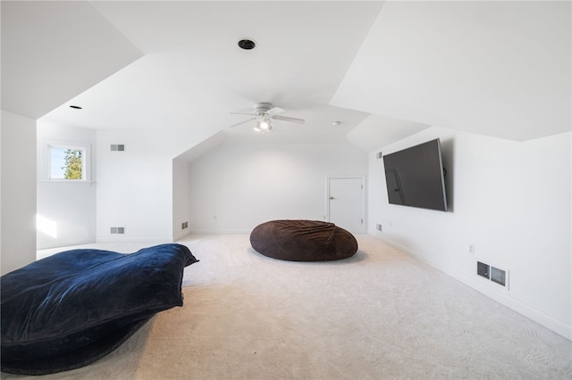 interior space featuring light carpet, lofted ceiling, and ceiling fan