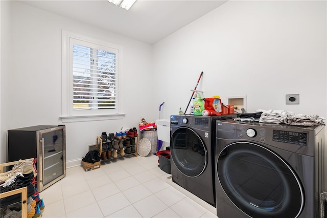 laundry area featuring independent washer and dryer and light tile patterned floors