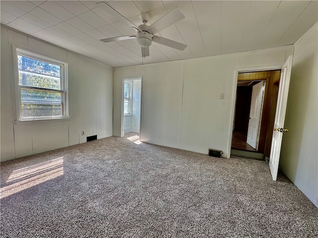 carpeted spare room with ceiling fan