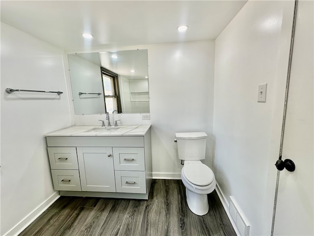 bathroom featuring hardwood / wood-style floors, toilet, and vanity