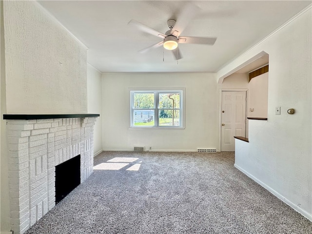 carpeted living room with ceiling fan and a fireplace