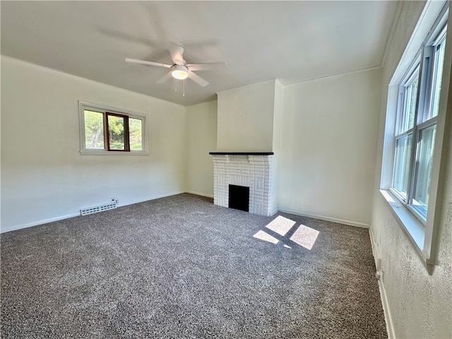 unfurnished living room with ceiling fan, carpet floors, and a fireplace