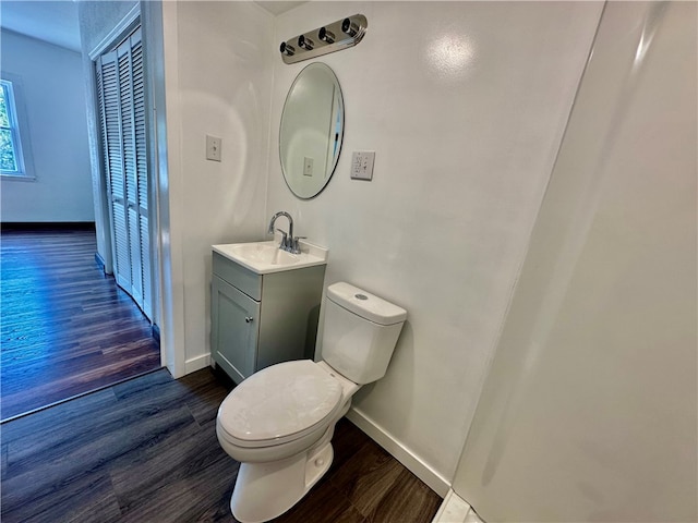 bathroom featuring vanity, toilet, and hardwood / wood-style floors