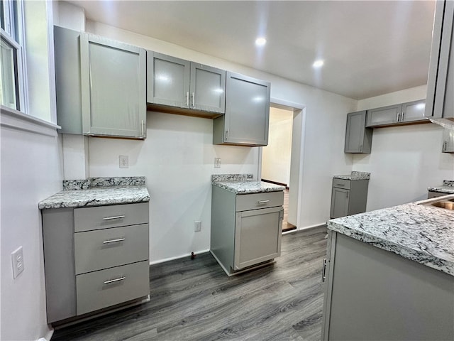 kitchen featuring sink, gray cabinets, and wood-type flooring