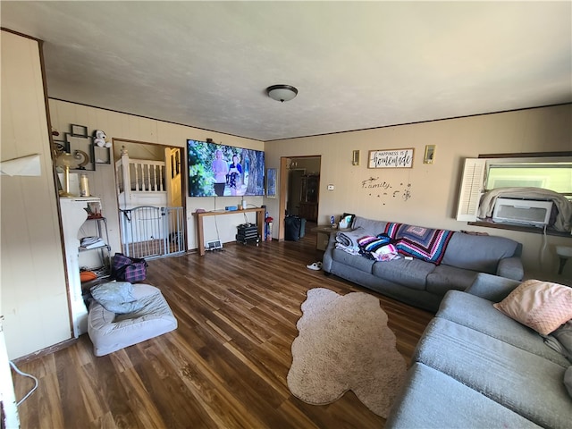 living room with wooden walls and hardwood / wood-style flooring