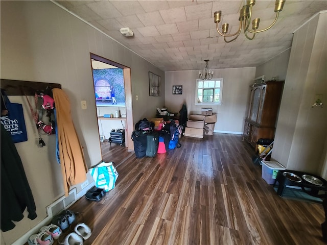 miscellaneous room with dark hardwood / wood-style flooring and a notable chandelier