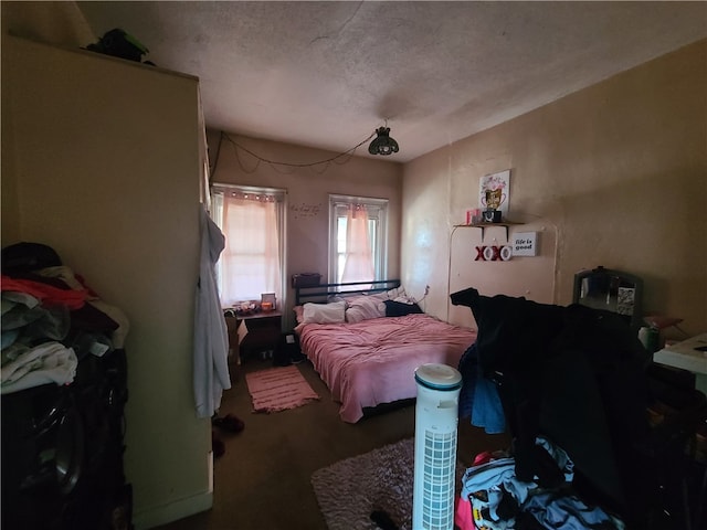 bedroom with carpet floors and a textured ceiling