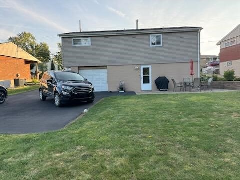 exterior space featuring a yard and a garage