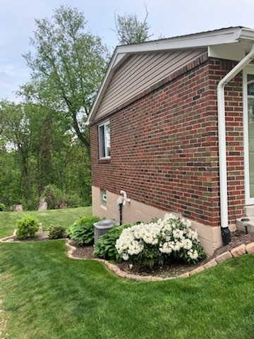 view of side of home featuring a yard