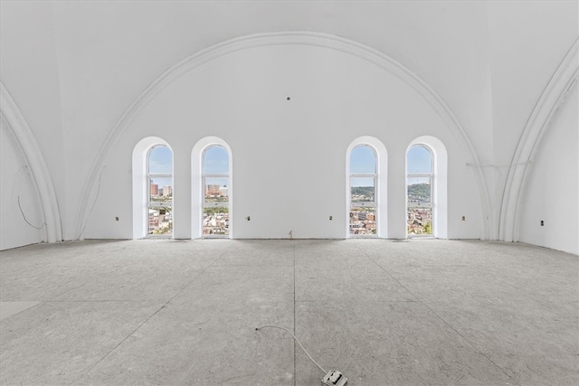 spare room with a towering ceiling