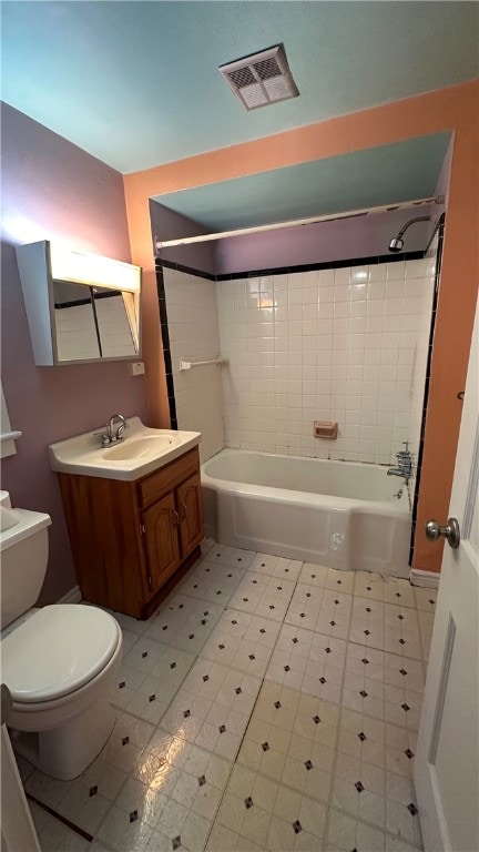 full bathroom with tiled shower / bath combo, toilet, and vanity