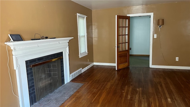 unfurnished living room featuring dark hardwood / wood-style floors