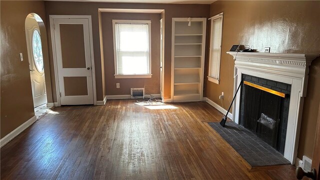 unfurnished living room featuring dark hardwood / wood-style flooring