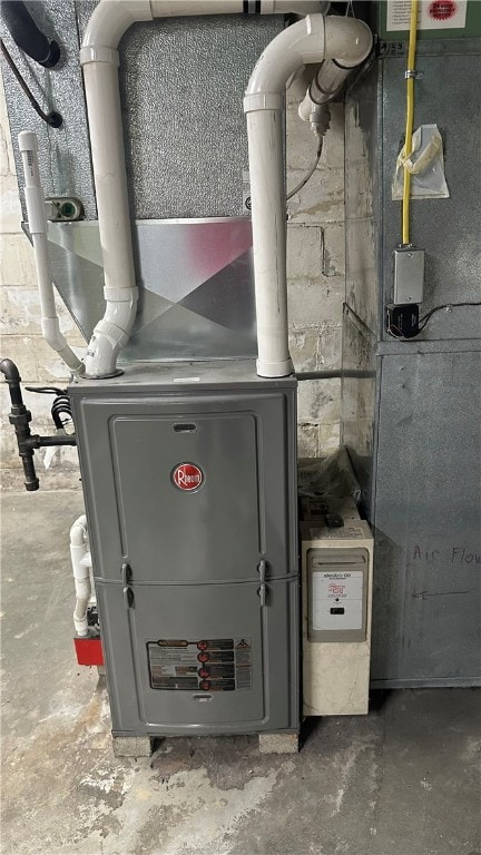 utility room featuring heating unit