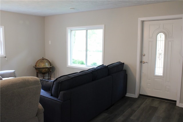 living room featuring a textured ceiling and dark wood-type flooring