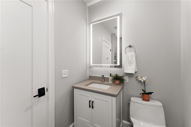 bathroom featuring vanity and toilet