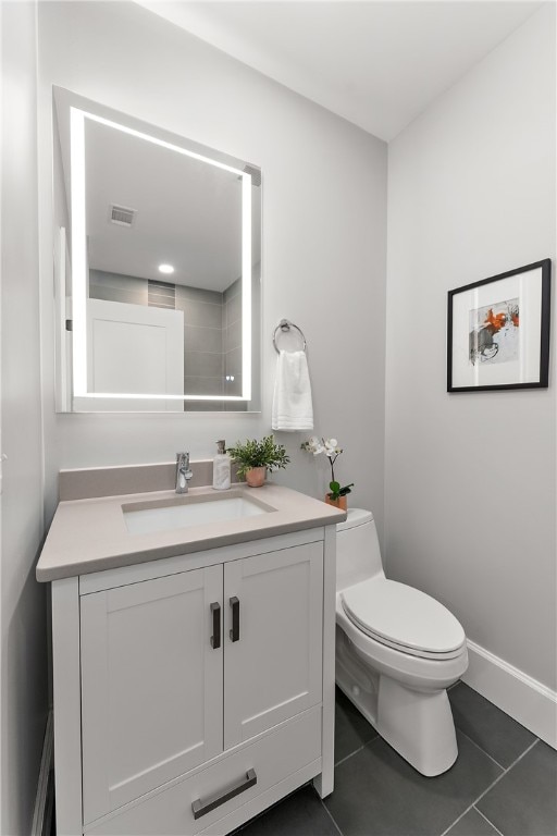 bathroom featuring vanity, toilet, and tile patterned floors