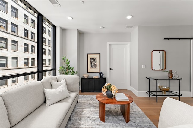 living room with expansive windows and light hardwood / wood-style floors