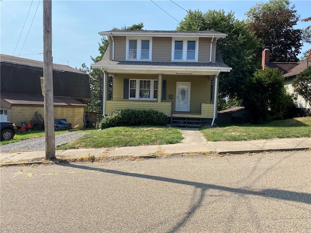 view of front facade with a front lawn and covered porch