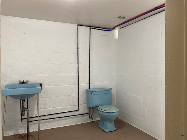 bathroom featuring concrete floors and toilet