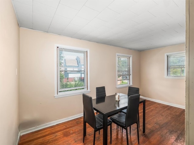 dining space featuring dark wood-type flooring and a wealth of natural light