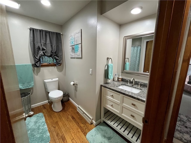 bathroom with vanity, toilet, and wood-type flooring