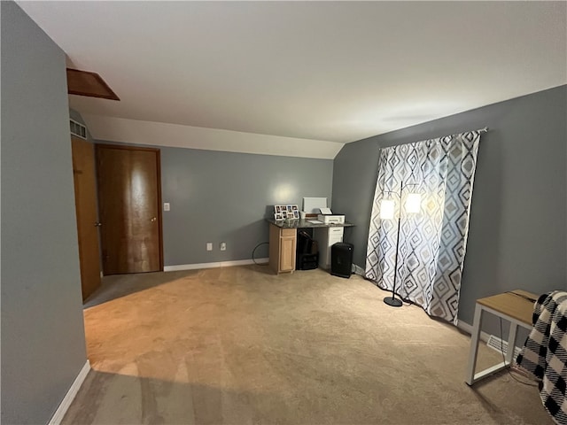 interior space featuring lofted ceiling and light colored carpet