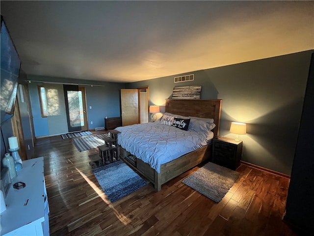 bedroom with dark wood-type flooring