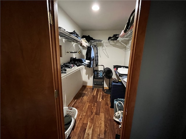 spacious closet with dark hardwood / wood-style floors