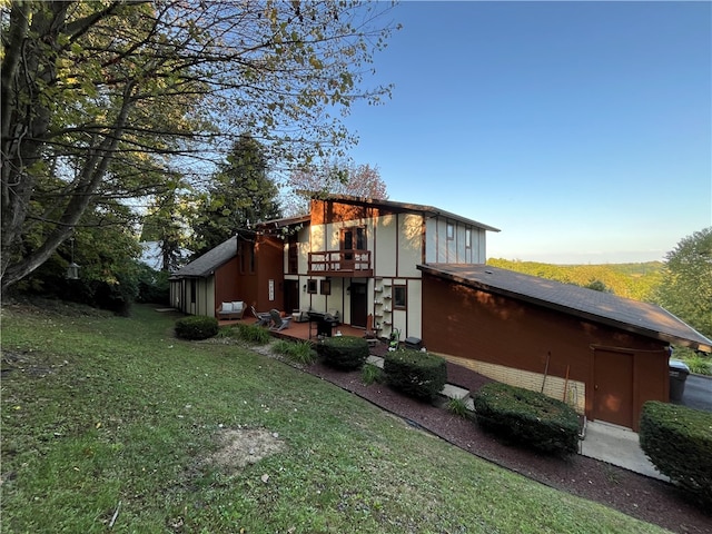 view of side of property featuring a patio area and a lawn