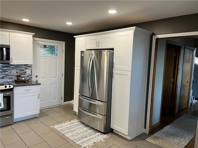 kitchen featuring backsplash, appliances with stainless steel finishes, and white cabinetry