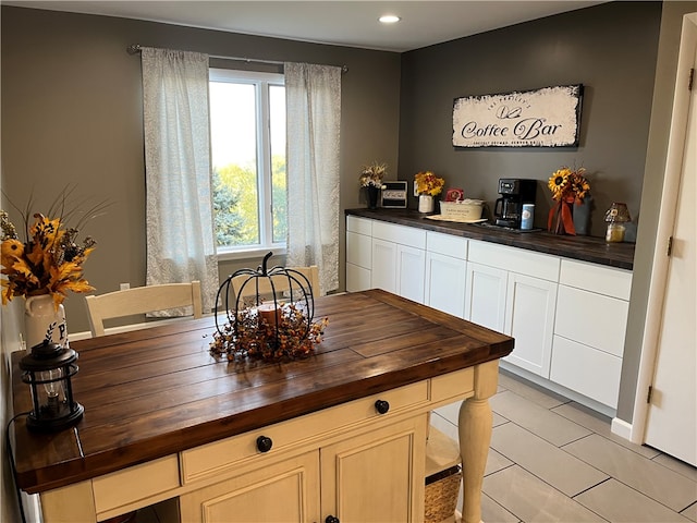 kitchen featuring butcher block countertops and light tile patterned flooring