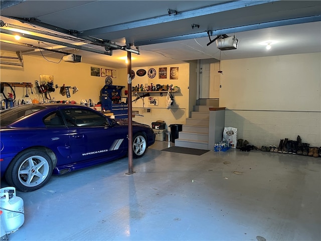 garage with a workshop area and a garage door opener