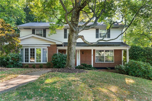 front facade featuring a porch and a front lawn