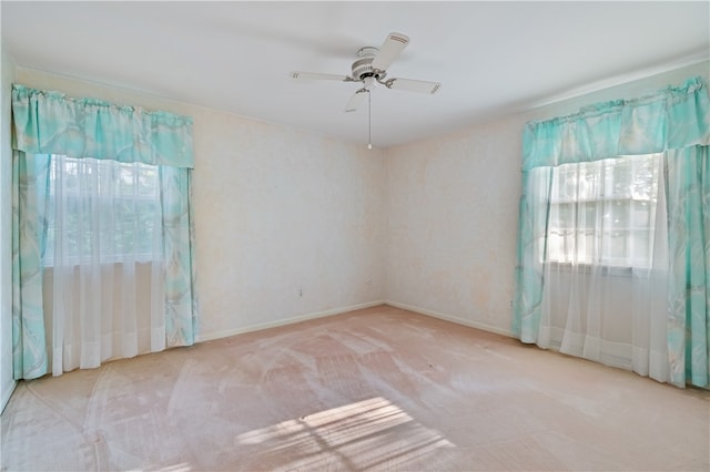 unfurnished room featuring ceiling fan and light colored carpet