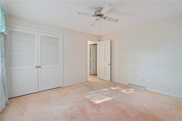 unfurnished bedroom featuring light colored carpet, ceiling fan, and a closet