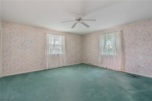 carpeted empty room featuring ceiling fan