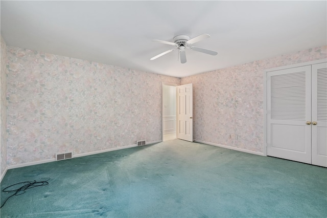 unfurnished bedroom with a closet, ceiling fan, and carpet flooring